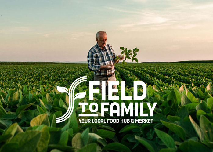 farmer standing in field with crops